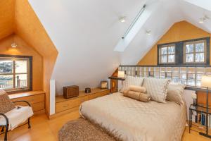 a bedroom with a bed and a chair in a attic at Galena Chalet - Valley View 1 Br 1 Ba 2 Half Ba Sleeps 6 in Telluride
