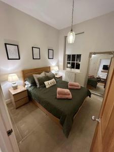 a bedroom with a bed with two towels on it at Luxury 1 Bedroom Flat in Great Location in Bicester