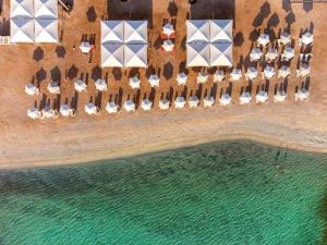 an aerial view of a resort with chairs and water at Rixos Premium Seagate in Sharm El Sheikh