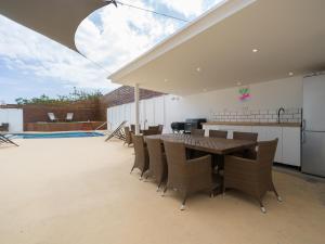 a patio with a table and chairs and a pool at Florida Home Private pool and Jacuzzi in San Bartolomé