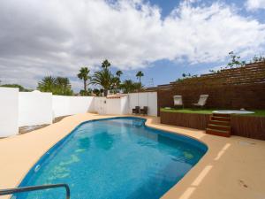 Una piscina en un patio trasero con una pared de ladrillos. en Florida Home Private pool and Jacuzzi, en Playa del Inglés