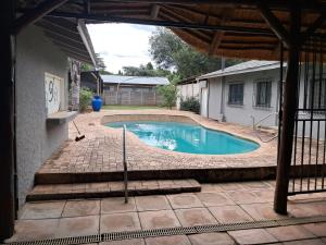 a swimming pool in the middle of a yard at Greenfield in Klerksdorp