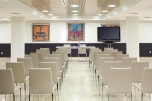 a conference room with chairs and a tv at NH Ciudad de Santander in Santander +17 photos
