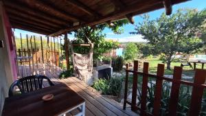 a deck with a hammock and a fireplace at Las Acacias Refugio in La Falda