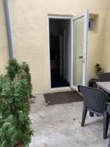 an open door to a patio with a table and chairs at Vintage Room in private house in Bucharest