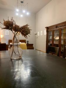 a vase with flowers sitting on top of a table at Vintage Room in private house in Bucharest