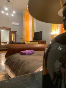 a bedroom with a bed with a purple pillow on it at Vintage Room in private house in Bucharest +16 photos