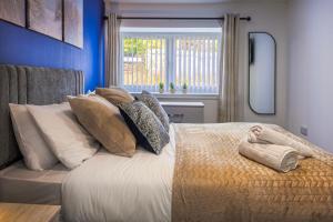 a bedroom with a bed with pillows and a window at Duffus Nights in Duffus