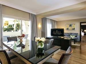 a living room with a dining table and a living room at Rixos Sharm El Sheikh - Adults Only 18 Plus in Sharm El Sheikh