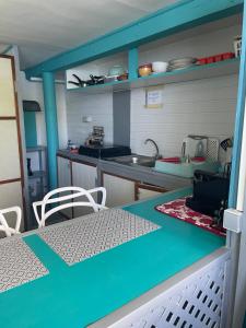 a small kitchen with a table and a counter top at Cottage Beach in Orufara