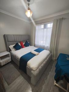 a bedroom with a large bed and a window at R&R -Weber One bedroom Naivasha, Old Naivasha Moi South lake road in Naivasha
