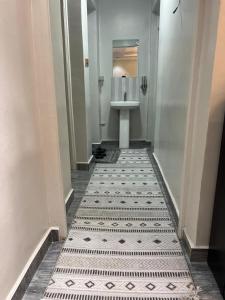a hallway with a bathroom with a sink and a toilet at R&R -Weber One bedroom Naivasha, Old Naivasha Moi South lake road in Naivasha
