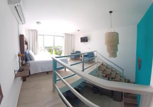 a large room with a bed and a staircase at Casa Linda Isla Loft- Ocean View- Shared Pool in Isla Mujeres +14 photos
