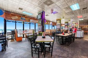 a restaurant with tables and chairs and windows at Sandy Horizon in Myrtle Beach