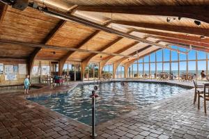 a large swimming pool in a building with people in it at Sandy Horizon in Myrtle Beach
