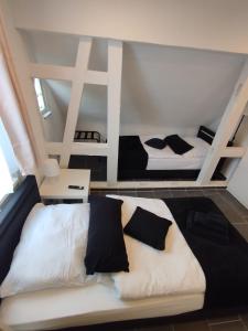 a bedroom with two beds in a room at Ferienwohnungen Calwer Höfle Marktplatz in Calw +45 photos