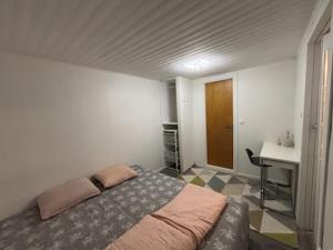 a bedroom with a bed and a desk in it at Stuga in Gothenburg