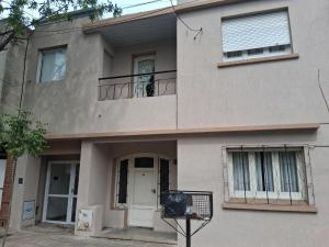 a house with a door and a balcony at la piazza in La Porteña