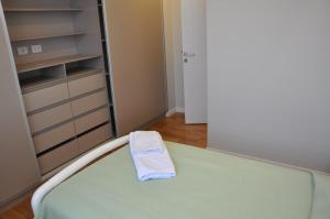 a bedroom with a bed with a towel on it at Condo en Cochabamba in Cochabamba +32 photos