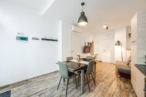 a dining room and living room with a table and chairs at Appartamento Bologna SantOrsola in Bologna +31 photos