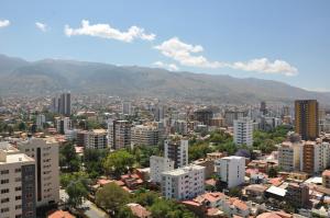 a city with buildings and mountains in the background at Condo en Cochabamba in Cochabamba