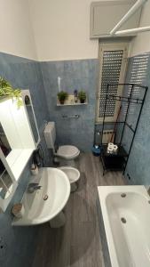 a bathroom with two toilets and a sink and a tub at Casa Amore a Bergamo in Bergamo +44 photos