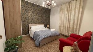 a bedroom with a bed and a red couch at Casa Amore a Bergamo in Bergamo