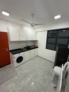 a kitchen with white cabinets and a sink and a dishwasher at apartment in hulhumale' in Hulhumale
