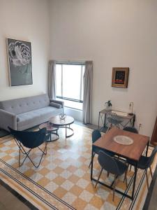 a living room with a couch and a table and chairs at Casa Monarcas - Josefina (with AC) in Guadalajara