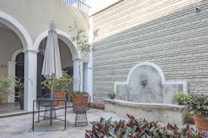 a patio with an umbrella and a fountain at Casa Monarcas - Josefina (with AC) in Guadalajara