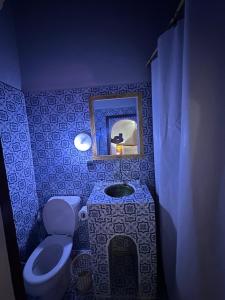 a bathroom with a sink and a toilet and a mirror at Riad Dar Zaouia in Zagora +136 photos
