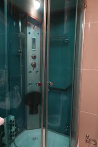 a shower with a glass door in a bathroom at Apartman 601 i 603 Kopaonik Centar in Kopaonik +43 photos
