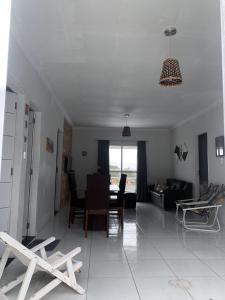 a living room with a couch and a table at Refúgio Lumare in Maragogi