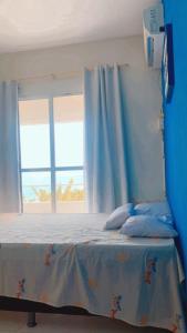 a blue bedroom with a bed with a window at Refúgio Lumare in Maragogi +12 photos