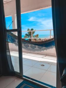 a view of a hammock from a room with a window at Refúgio Lumare in Maragogi +8 photos