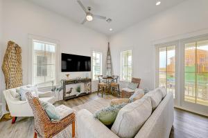 a living room with a couch and chairs and a tv at Vida del Mar in Mustang Beach