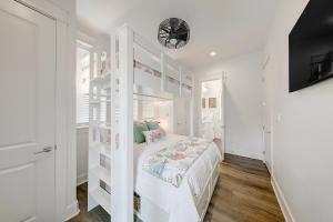 a bedroom with a white bunk bed and a tv at Vida del Mar in Mustang Beach +30 photos