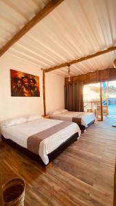 une chambre avec deux lits dans une pièce dans l'établissement Rocha Beach Club, à Playa Blanca
