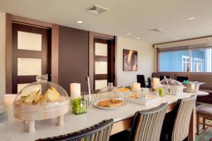 a dining room with a table with food on it at Residence Inn by Marriott Kingston in Kingston