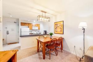 a kitchen and dining room with a table and chairs at Town Plaza, Unit 209 in Whistler