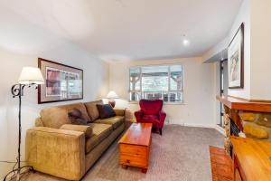 a living room with a couch and a table at Town Plaza, Unit 209 in Whistler