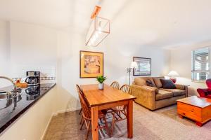 a living room with a table and a couch at Town Plaza, Unit 209 in Whistler