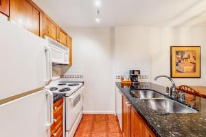 a kitchen with a sink and a stove at Town Plaza, Unit 209 in Whistler +11 photos
