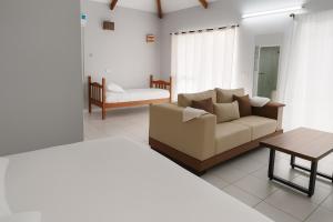 a living room with a couch and a table at Hotel Albatros Wallis 