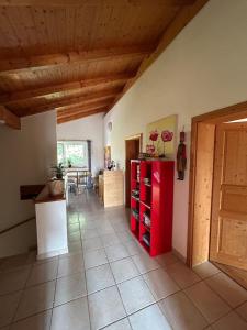 a room with a red refrigerator and a table at Casa Boebelle in Bük