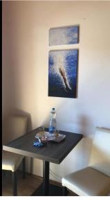 a table with a plate of food and a bottle on it at Casa Boebelle in Bük