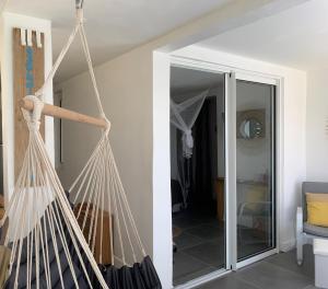 a hammock hanging in a room with a doorway at Le 35 Anse des Rochers Saint-François in Saint-François +40 photos