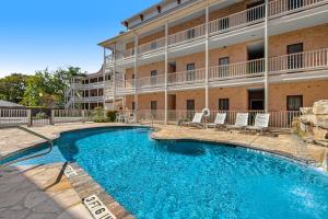 a swimming pool in front of a building at The Village at Gruene - Unit 203 in Gruene