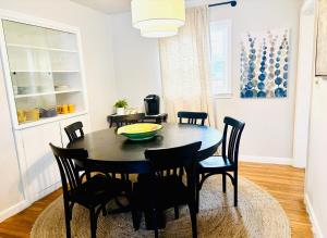 a dining room with a black table and chairs at Entire home, 6 min drive to UIUC in Champaign