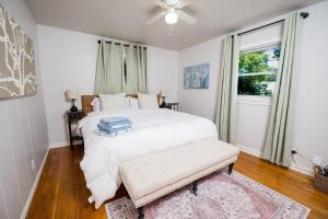 a bedroom with a white bed and a window at Entire home, 6 min drive to UIUC in Champaign